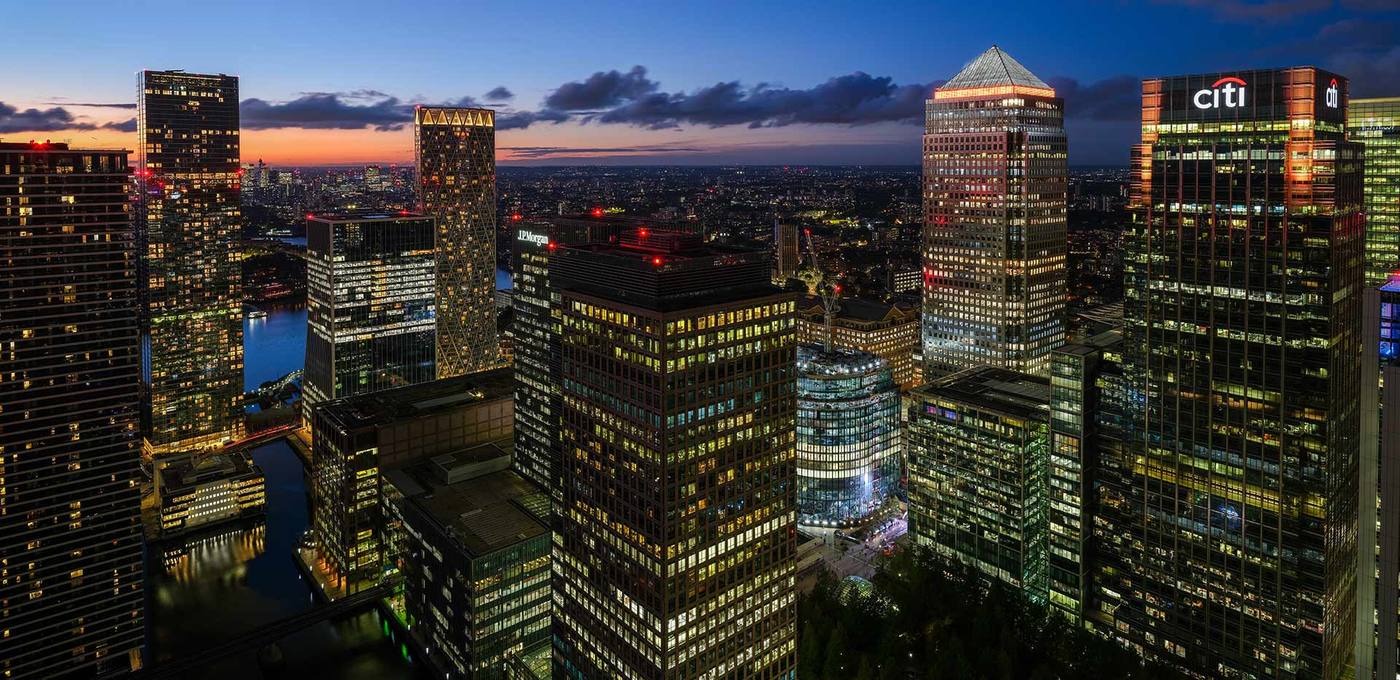Riverside towers and the Canary Wharf skyline at dusk