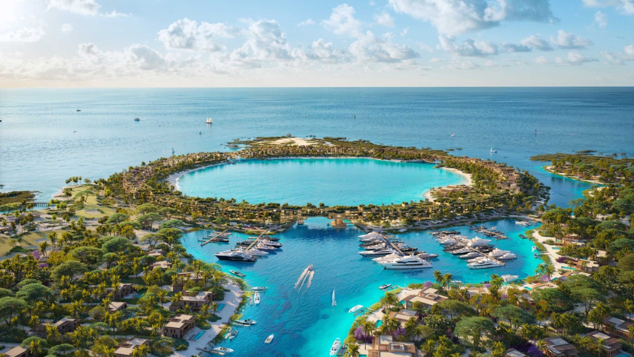 Island residences around a turquoise lagoon and marina